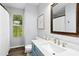 Bathroom with a blue vanity, a white countertop, and a window with natural light at 624 Wait Ave, Wake Forest, NC 27587