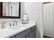 Bathroom featuring a white countertop, a wood-framed mirror, and a shower with patterned curtains at 624 Wait Ave, Wake Forest, NC 27587