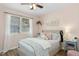 Pink bedroom with a queen-sized bed, patterned bedding, and a window with blinds at 624 Wait Ave, Wake Forest, NC 27587
