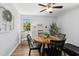 Bright dining area with views of nature, featuring a rustic wooden table and an exercise machine in the corner at 624 Wait Ave, Wake Forest, NC 27587