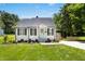 Charming one-story home with a well-manicured lawn and a delightful light-blue front door at 624 Wait Ave, Wake Forest, NC 27587
