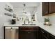 Well-lit kitchen with stainless steel appliances, white countertops, and dark brown cabinetry at 624 Wait Ave, Wake Forest, NC 27587