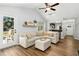Bright living room with a vaulted ceiling, comfortable sofa, and seamless flow to the outdoor area at 624 Wait Ave, Wake Forest, NC 27587