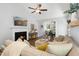 Cozy living room with a fireplace, vaulted ceiling, and comfortable seating, with an open view to the dining area at 624 Wait Ave, Wake Forest, NC 27587