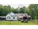 Charming home with white siding, green shutters, and a fenced yard at 67 Bull Run N, Timberlake, NC 27583