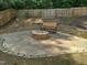 Backyard featuring a built-in stone firepit area with a seating bench, perfect for entertaining at 7 Mint Hill Ct, Durham, NC 27703