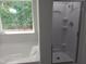 Bathroom featuring tub, shower stall and view out of the window at 7 Mint Hill Ct, Durham, NC 27703