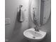 Half bathroom featuring a single sink with chrome faucet, oval mirror, and towel rack at 7 Mint Hill Ct, Durham, NC 27703