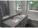 Bathroom featuring double sinks, granite countertops, and large mirrors at 7 Mint Hill Ct, Durham, NC 27703