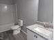 Bathroom featuring a single sink, shower-tub combination, granite countertop, and vinyl floors at 7 Mint Hill Ct, Durham, NC 27703