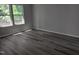 Bedroom featuring wood-look floors and a large window for ample natural light at 7 Mint Hill Ct, Durham, NC 27703