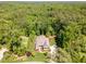 Aerial view of a brick home surrounded by mature trees and lush green landscaping at 7108 Carries Reach Way Way, Raleigh, NC 27614