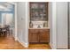 Elegant bar area with custom cabinetry, countertop, and glassware storage at 7108 Carries Reach Way Way, Raleigh, NC 27614