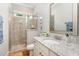 Bright bathroom featuring a granite countertop, white cabinets, and a glass enclosed shower at 7108 Carries Reach Way Way, Raleigh, NC 27614