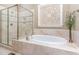 Bright bathroom features a large soaking tub and glass-enclosed shower at 7108 Carries Reach Way Way, Raleigh, NC 27614