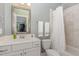 Cozy bathroom featuring tiled shower, neutral paint, framed mirror, and white marble vanity at 7108 Carries Reach Way Way, Raleigh, NC 27614