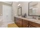 Bathroom features a double vanity with granite countertops and framed mirrors at 7108 Carries Reach Way Way, Raleigh, NC 27614