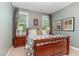 Bedroom with wood furnishings, neutral tones, and natural lighting at 7108 Carries Reach Way Way, Raleigh, NC 27614