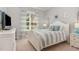 Comfortable bedroom with a white-striped bed, plush pillows, and a window for natural light, creating a relaxing space at 7108 Carries Reach Way Way, Raleigh, NC 27614