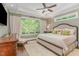 Cozy bedroom with a large window, neutral-toned walls, and plush bedding, creating a relaxing atmosphere at 7108 Carries Reach Way Way, Raleigh, NC 27614