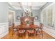 Elegant dining room featuring a coffered ceiling, hardwood floors, and stylish furniture, perfect for entertaining at 7108 Carries Reach Way Way, Raleigh, NC 27614