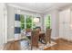 Bright dining area with large windows and stylish curtains. Dining room seats four at 7108 Carries Reach Way Way, Raleigh, NC 27614