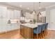 Modern kitchen features stainless steel appliances, subway tile backsplash and an island with seating at 7108 Carries Reach Way Way, Raleigh, NC 27614