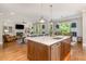 Gourmet kitchen with a large island and stainless appliances, seamlessly connects to living and dining areas at 7108 Carries Reach Way Way, Raleigh, NC 27614