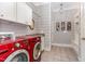 Bright laundry room with modern red washer and dryer at 7108 Carries Reach Way Way, Raleigh, NC 27614