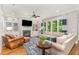 Inviting living room featuring a fireplace, built-in shelves, hardwood floors, and a comfortable seating arrangement at 7108 Carries Reach Way Way, Raleigh, NC 27614