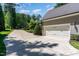 Long driveway leading to a spacious side load garage on a sunny day at 7108 Carries Reach Way Way, Raleigh, NC 27614