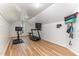 Bright workout room with paneled walls, wood floors, bike, and treadmill at 7108 Carries Reach Way Way, Raleigh, NC 27614