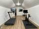 Spacious workout room with treadmill, bike, wood floors and paneled walls at 7108 Carries Reach Way Way, Raleigh, NC 27614