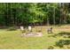 Fire pit with chairs nestled among trees for cozy outdoor gatherings at 7200 Rabbit Run, Wake Forest, NC 27587