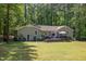 Inviting backyard with a spacious deck, patio furniture, and beautiful landscaping for relaxing outdoor living at 7200 Rabbit Run, Wake Forest, NC 27587