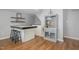 Stylish bar area with stools, modern shelving, and sleek design, perfect for entertaining at 7200 Rabbit Run, Wake Forest, NC 27587