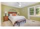 Comfortable bedroom with a queen-size bed, ceiling fan, and ample natural light at 7200 Rabbit Run, Wake Forest, NC 27587