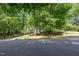 Charming home nestled amongst mature trees and lush landscaping, with a long driveway leading to the property at 7200 Rabbit Run, Wake Forest, NC 27587