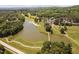 An aerial view of a golf course featuring a large lake, lush greens, and a well-appointed clubhouse at 72103 Moseley, Chapel Hill, NC 27517