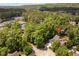 An aerial view showcases the house nestled amongst trees, with access to tennis courts and the golf course at 72103 Moseley, Chapel Hill, NC 27517