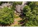 Beautiful home from above with a private deck surrounded by lush trees and manicured lawn at 72103 Moseley, Chapel Hill, NC 27517