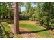 Large grassy backyard with mature trees provides privacy and space for outdoor activities and enjoyment at 72103 Moseley, Chapel Hill, NC 27517