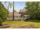 Brick home with a deck overlooking the spacious backyard, surrounded by lush greenery and mature trees at 72103 Moseley, Chapel Hill, NC 27517