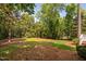 This backyard features mature trees and a private wooded area, creating a serene outdoor space at 72103 Moseley, Chapel Hill, NC 27517