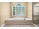 Relaxing bathroom featuring a tiled tub and a separate shower, creating a serene atmosphere at 72103 Moseley, Chapel Hill, NC 27517