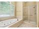 Bright bathroom with a garden tub and a glass-enclosed shower, perfect for unwinding after a long day at 72103 Moseley, Chapel Hill, NC 27517