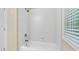Bathroom bathtub featuring a tiled surround and updated fixtures for relaxation and convenience at 72103 Moseley, Chapel Hill, NC 27517