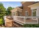Spacious wooden deck offers ample space for outdoor gatherings and relaxation, adjacent to the brick home at 72103 Moseley, Chapel Hill, NC 27517