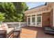 Well-maintained deck with furniture and awning provides a relaxing outdoor living space with brick home at 72103 Moseley, Chapel Hill, NC 27517
