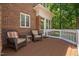 Brick home boasts a beautiful deck area with outdoor seating, ideal for relaxation and entertaining at 72103 Moseley, Chapel Hill, NC 27517